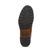 Bottom tread of a boot against a white background. The tread is a black color with a brown accent running through the center of it. 