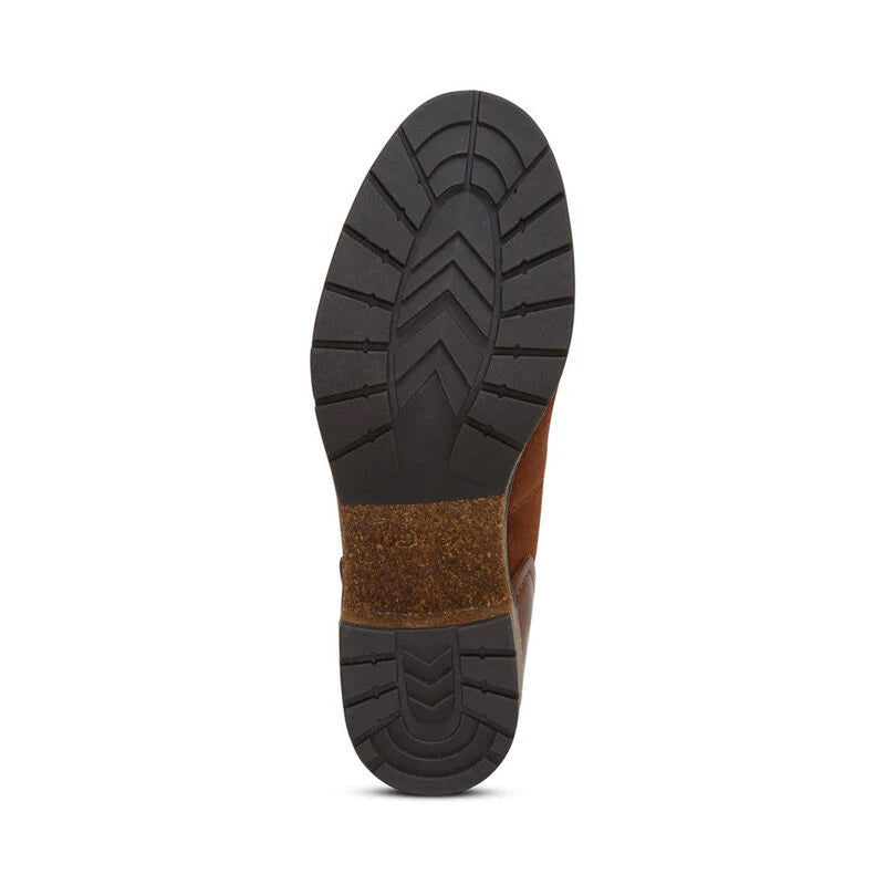 Bottom tread of a boot against a white background. The tread is a black color with a brown accent running through the center of it. 