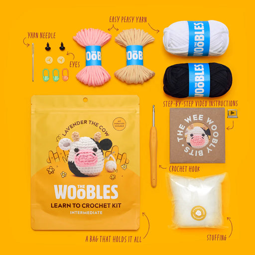 Woobles crochet kit with yarn, needle, eyes, hook, and instructions on a yellow background