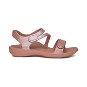 Pink sandal with 'Crocs' branding on a white background