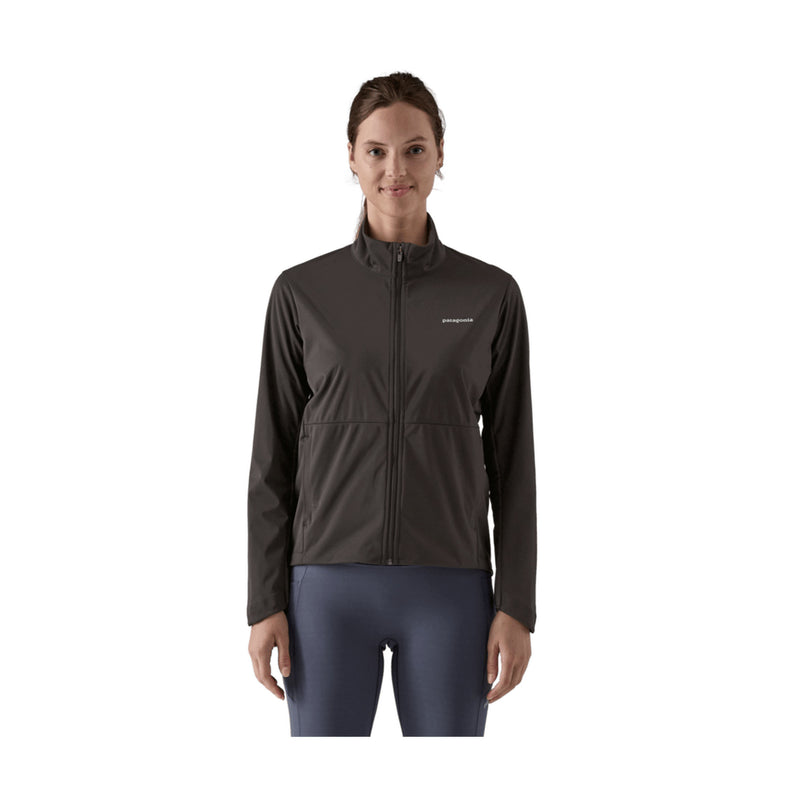 A woman modeling a dark brown Patagonia full-zip jacket with a stand-up collar, paired with dark blue leggings, against a plain white background.
