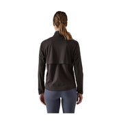 A woman viewed from the back wearing a dark brown long-sleeve athletic jacket and slate blue leggings against a plain white background.