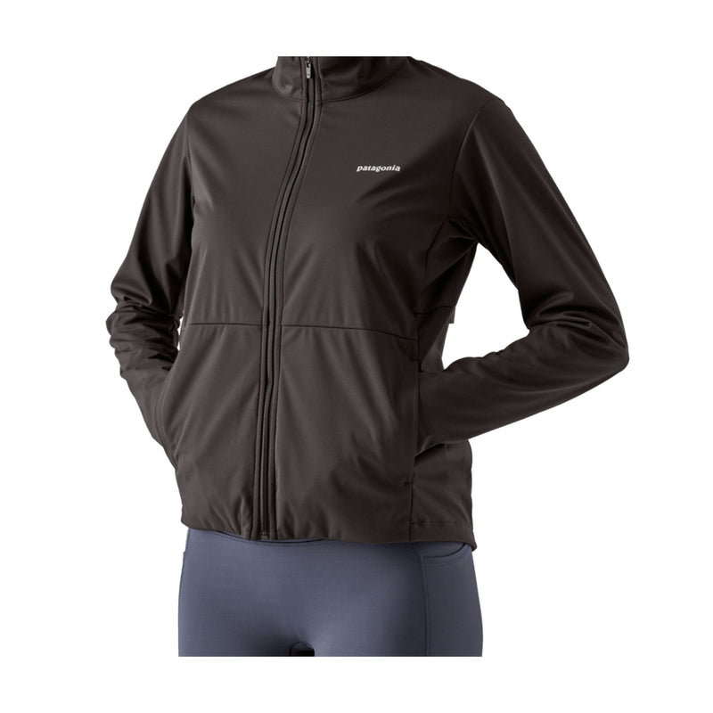 A dark brown Patagonia zip-up jacket with a small white logo on the left chest, shown on a model wearing gray leggings against a plain white background.