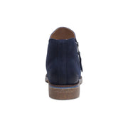 Back view of a blue colored ankle boot against a white background. 