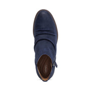 Top view of a blue colored ankle boot against a white background.
