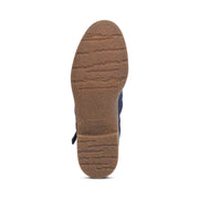 Bottom tread of a boot against a white background. The tread itself is completely brown in color.