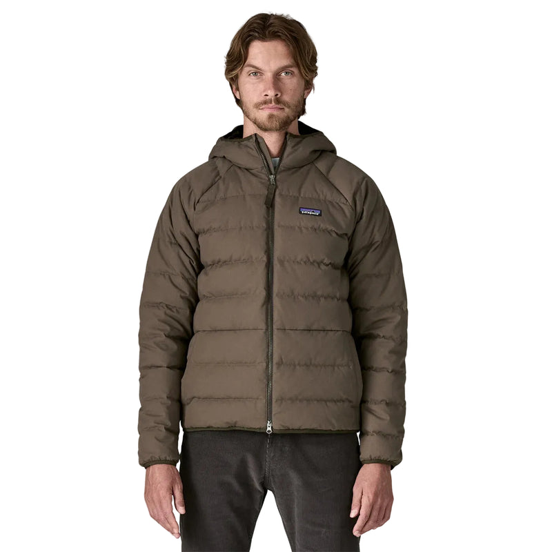 Man wearing a brown puffer jacket with a visible brand logo on a white background