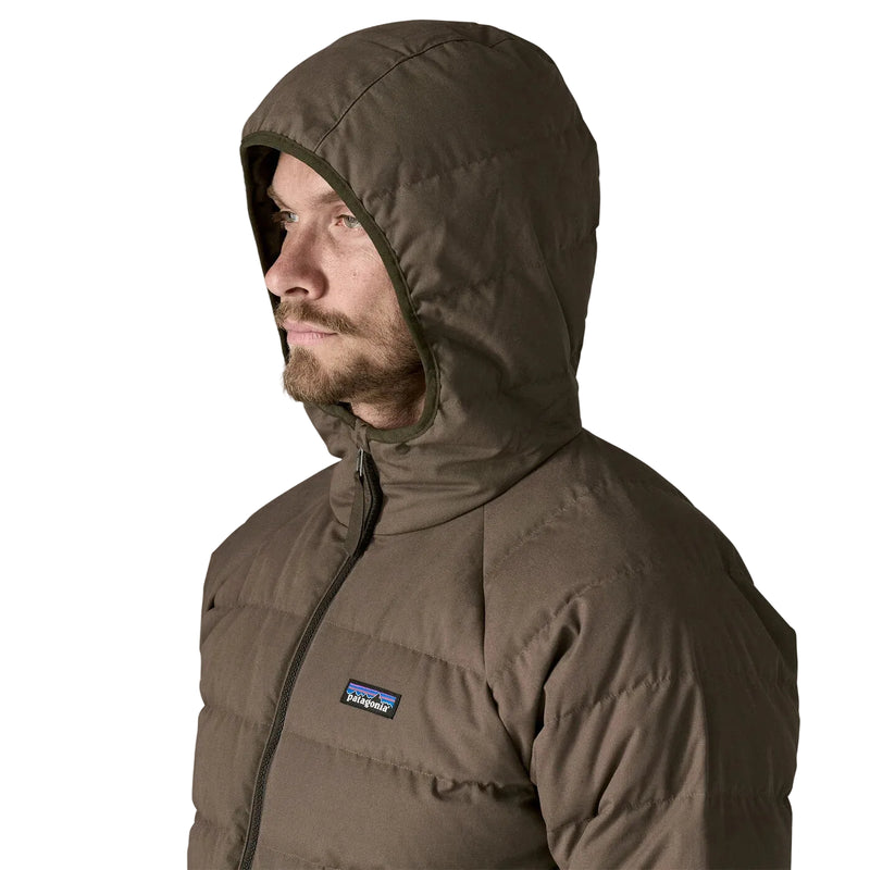 Man wearing a brown jacket with a hood on a white background