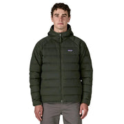 Man wearing a green puffer jacket with a brand logo on a white background