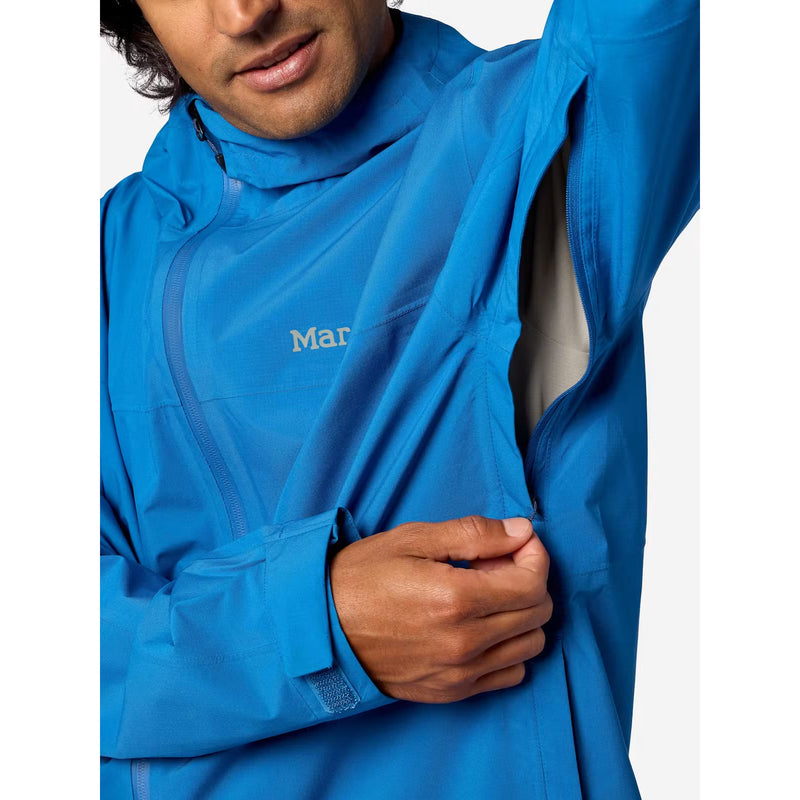 A close-up of a man wearing a bright blue technical outdoor jacket, showing the brand logo 'Mar' on the chest and the jacket's high collar and zippered front.