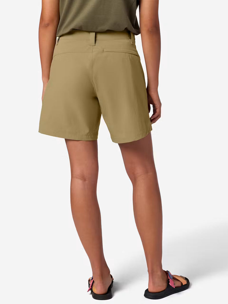 The back of a person wearing tan cargo shorts on a white background