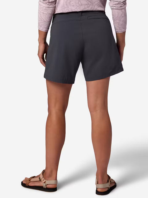 The back of a person wearing dark blue cargo shorts on a white background
