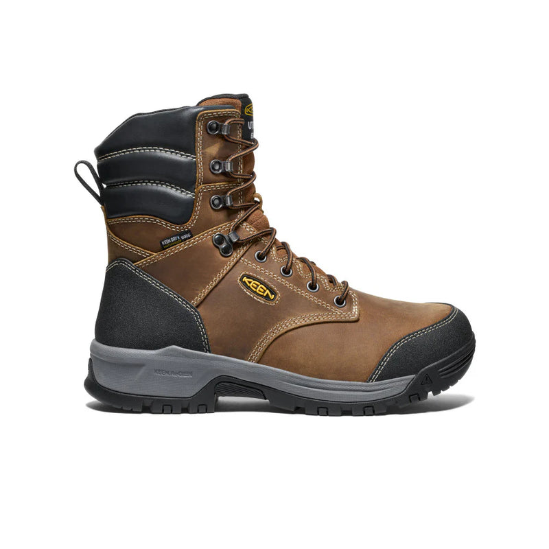 Side view of a brown and black work boot with yellow accents against a white background. 