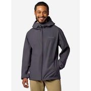 A man wearing a dark gray hooded rain jacket with a full front zipper and a small gray Menden brand logo on the left chest, paired with khaki pants, set against a plain light gray background.