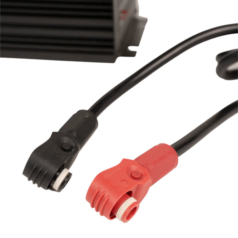 Close up image of a black cable and a red cable on a white background.