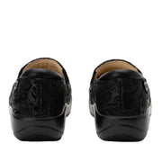 Black loafers with embossed design on a white background