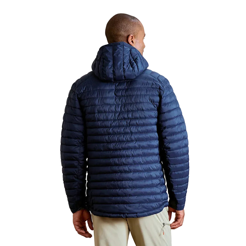Person wearing a blue puffer jacket on a plain background
