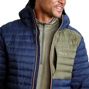 Man wearing a blue and green puffer jacket with 'Orvis' branding.