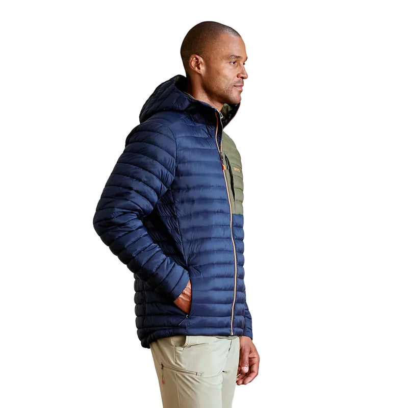 Man wearing a blue puffer jacket against a plain background