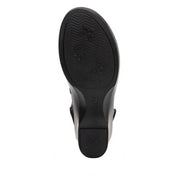 Bottom view of the black tread of a boot against a white background.