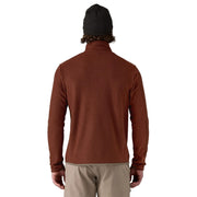 Person wearing a brown textured pullover on a white background