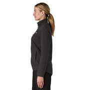 Woman wearing a black jacket with a visible brand logo on a white background