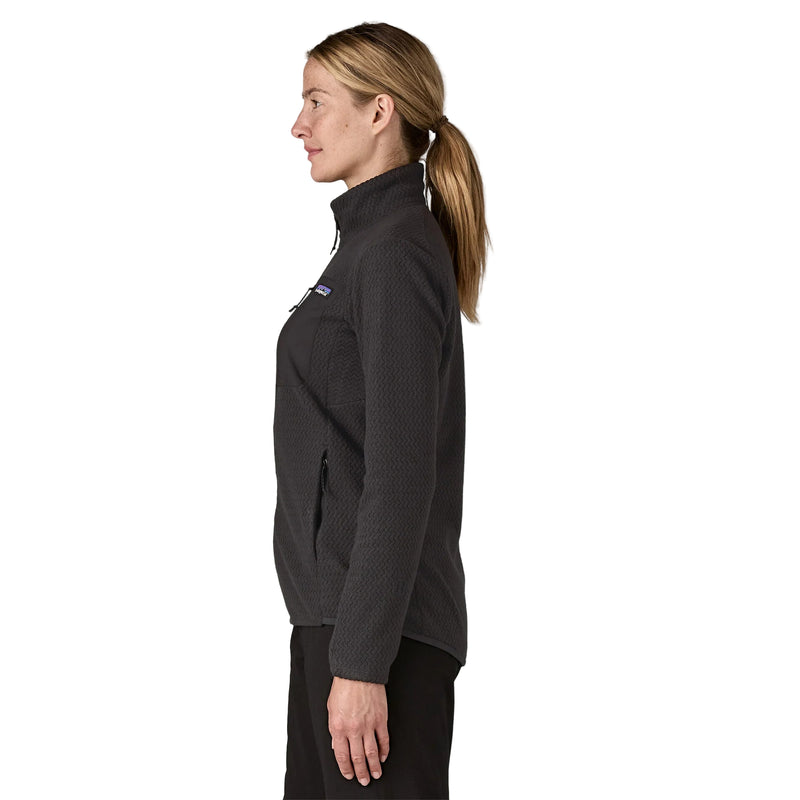 Woman wearing a black jacket with a visible brand logo on a white background