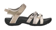 Pair of beige and black sandals on a white background