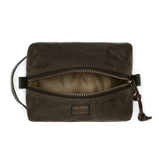 Dark green travel bag with Filson logo against a white background. 