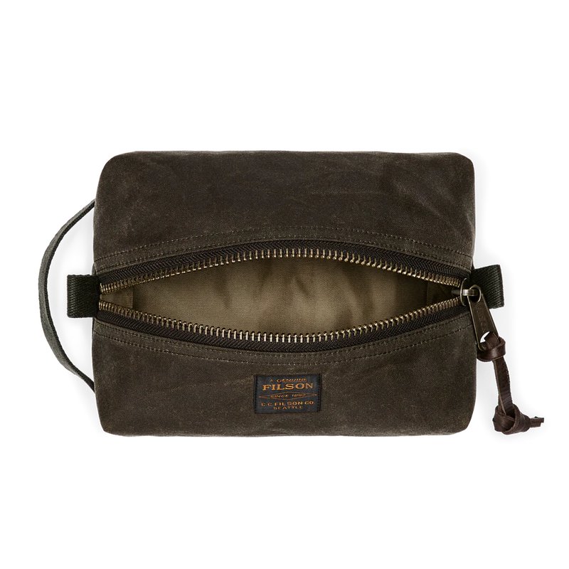 Dark green travel bag with Filson logo against a white background. 