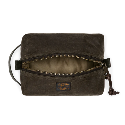 Dark green travel bag with Filson logo against a white background. 
