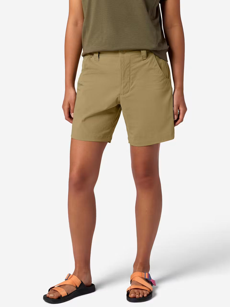 A person wearing tan cargo shorts on a white background