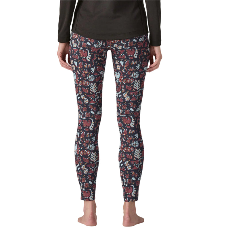 Person wearing floral patterned leggings on a white background