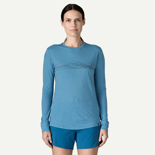 A person from the front wearing a blue long sleeve shirt on a white background