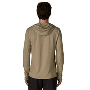 A person from behind wearing a beige hoodie on a white background