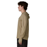 A person from the side wearing a beige hoodie on a white background