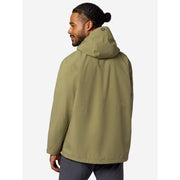 A man wearing an olive green hooded jacket, shown from a three-quarters back view against a light gray studio background.