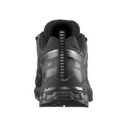 A black Salomon trail running shoe shown from the rear view, featuring a textured black and dark gray synthetic upper with a rugged sole, on a solid white background.