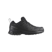 Black athletic shoe with orange accents on a white background