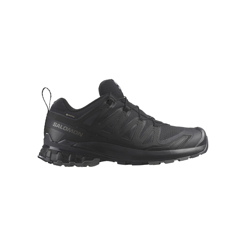 Black athletic shoe with orange accents on a white background