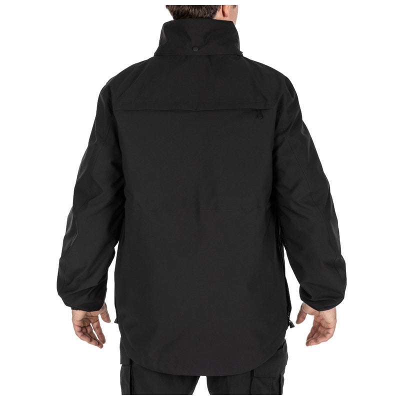 The back of a person wearing a black jacket on a white background