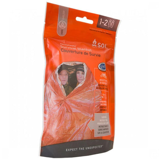 An orange bag with an orange survival blanket inside on a white background