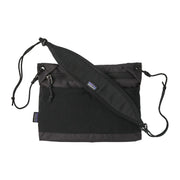 A black cross body bag on a white background