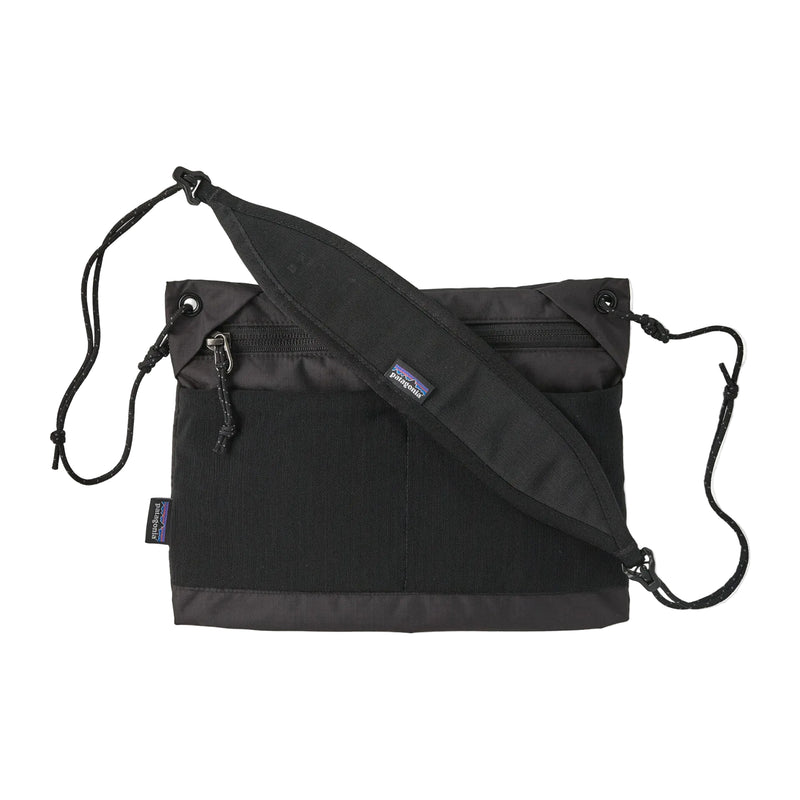 A black cross body bag on a white background
