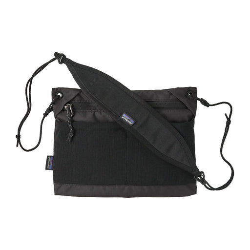 A black cross body bag on a white background