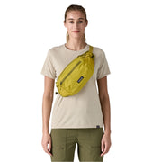 Person wearing a yellow waist bag on a white background