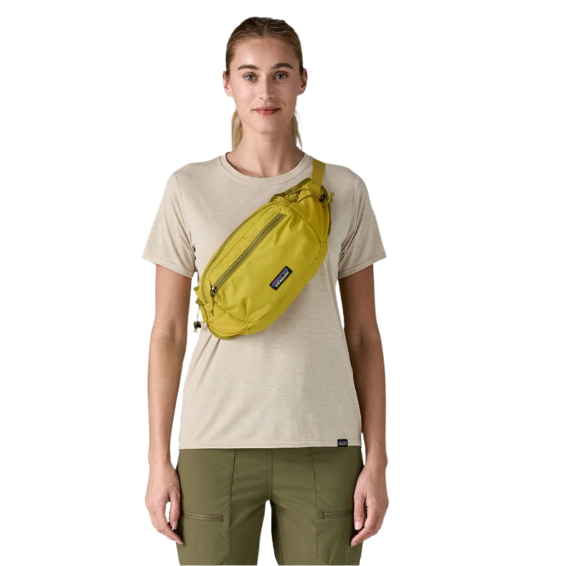 Person wearing a yellow waist bag on a white background