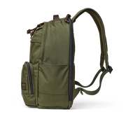 Side view of an olive colored backpack against a white background. 