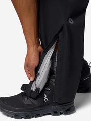 Person showing the open ankle at the hem of the pants to allow pants to fit over footwear. 