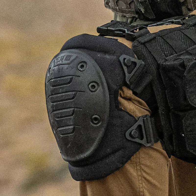 Close up of a man wearing a black knee pad in the wilderness. 
